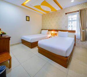 Postel nebo postele na pokoji v ubytování Boss Palace Hotel
