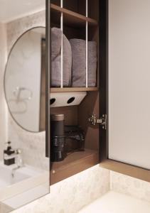 a bathroom with a sink and some towels at Wecostay Gangnam in Seoul +291 photos