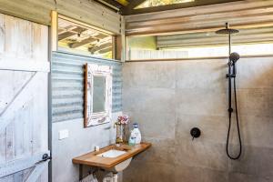 a bathroom with a sink and a shower at Mountain View Tilba Tilba - Glamping in Tilba Tilba