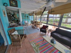 a living room with a couch and a table at Beach & Surf Hacienda on Hutchinson Island in Fort Pierce