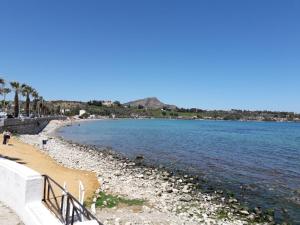 a beach next to a body of water at La casa di Ross in Casteldaccia