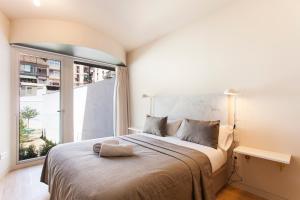 Postel nebo postele na pokoji v ubytování Aspasios City Oasis Apartments