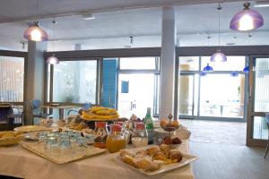a table with a bunch of food on it at Hotel San Terenzo in Lerici