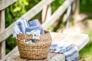 a basket of towels sitting on a wooden bench at Villa Bermeja in Casares