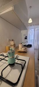a kitchen with a stove top oven next to a counter at Casa Vacanze L'Ortensia in Bagheria