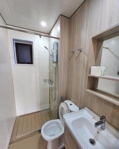 a bathroom with a shower and a toilet and a sink at Youth City@Nilai in Nilai
