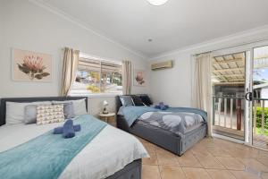 a bedroom with two beds and a window at Quadruple Ensuite Room - Nearby Stations & Shops in Regents Park