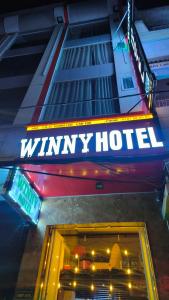 a wimpy hotel sign on the side of a building at Winny Hotel Ninh Kieu Quay in Can Tho