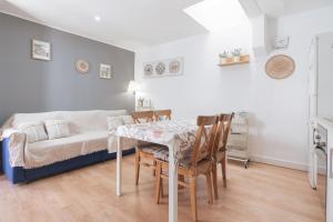 a dining room with a table and chairs and a couch at Oh La Lá in Tarragona