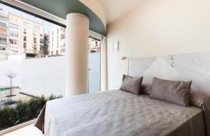Postel nebo postele na pokoji v ubytování Aspasios City Oasis Apartments