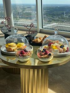 a table with several plates of food on top of it at Vilnius TV Tower Apartments DEBESYS in Vilnius