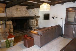 ein Wohnzimmer mit einem Sofa und einem Kamin in der Unterkunft Grand gîte au pays des lavandes in Aurel