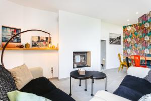 a living room with a couch and a table at Gite les 3 piliers in Pissotte