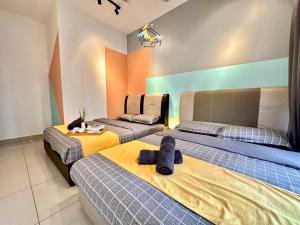 two beds in a room with orange and blue at SeaView PoolView CityView BaliResidence Video game 5minJonker in Melaka