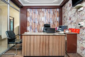 an office with a reception desk with a stone wall at City Star Hotel & Restaurant in Jawāharnagar
