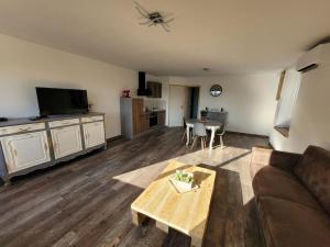 a living room with a couch and a table at T2 plain-pied, en centre-ville in Buzançais