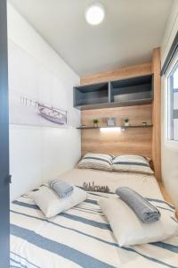 a bedroom with a large bed with two pillows at Mobile home Mia & Roko - Beach Porat, Drage in Drage