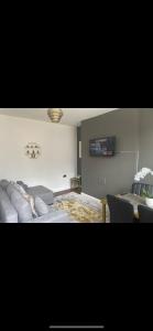 ein Wohnzimmer mit einem Sofa und einem TV in der Unterkunft Clifton Home - Newly refurbished - Perfect for contractors! in Killingbeck