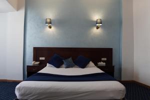 a bedroom with a large bed with blue walls at Amon Alexandria in Alexandria