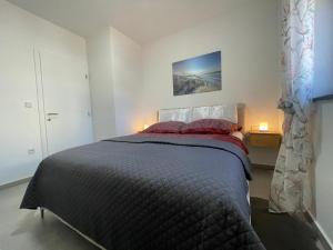 a bedroom with a bed and a painting on the wall at Villa Narona in Medulin +62 photos