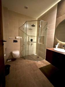 y baño con ducha, aseo y lavamanos. en The Ivory Hotel en Nairobi