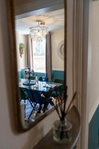 a dining room with a table and a mirror at The Plumb Townhouse in Warwick Centre in Warwick