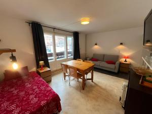 a room with a bed and a table and a couch at Immodelpas La residence in Pas de la Casa