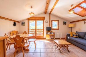a living room with a table and a couch at Les Belles d'Arly - Appt vue montagne in Praz-sur-Arly