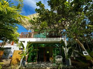 a house with a balcony on top of it at 蓝色引力潜水度假村BLUE GRAVITY.WOW DIVING in Panglao Island