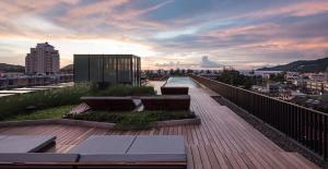a balcony with benches and a view of a city at The Deck Condominium Patong Beach in Patong Beach +31 photos
