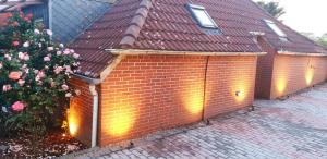 a brick building with a brown roof and a christmas tree at Boje 34 in Osteel