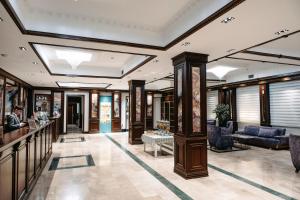 a lobby of a hotel with a bar and couches at Grand Hotel Baku Central Park in Baku