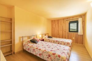 1 Schlafzimmer mit 2 Betten und einem Fenster in der Unterkunft El Refugi De Rubinat in Sant Antolí i Vilanova