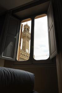 a view of a clock tower through a window at Signoria n&deg;5 in Florence