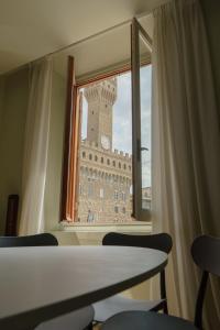 a view of a clock tower from a window at Signoria n&deg;5 in Florence