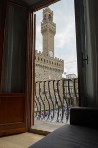 a view of a clock tower from a window at Signoria n&deg;5 in Florence