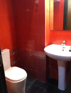 a bathroom with a white toilet and a sink at Cozy apartment in the city center in Tbilisi City