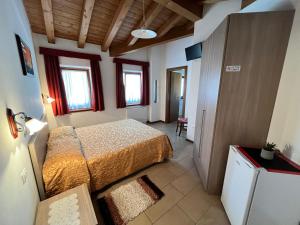Postel nebo postele na pokoji v ubytování Agriturismo e Alloggi Luis Gianni