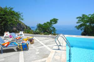 a swimming pool with a view of the ocean at Villa Cala del Marò in Praiano