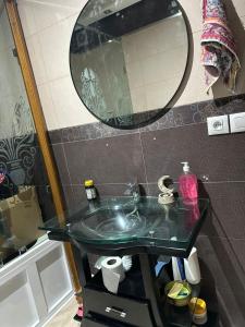 a bathroom with a sink and a mirror at Appartement Tanger Lux in Tangier +4 photos