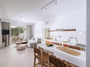 a kitchen and living room with a table and chairs at Nostos Brand new Private Villa in Pitsidia