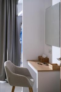 a white room with a chair and a desk at Nostos Brand new Private Villa in Pitsidia