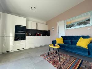 a living room with a blue couch and a table at Villa Narona in Medulin