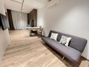 a living room with a couch and a table at KK Home - Bugis Service Apartment Suite in Singapore