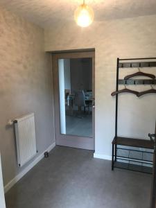 a room with a hallway with a mirror and a table at Escale in La Motte-Servolex