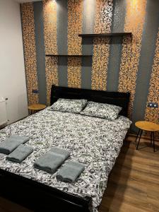a bedroom with a bed with two pillows on it at VIP апартаменти ЦЕНТР in Rivne