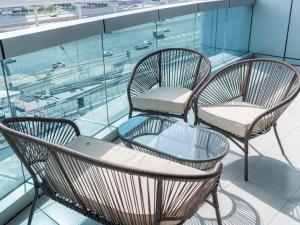 three chairs and a table on top of a building at Dubai Marina Stunning Huge 4 Bedroom Apts Near JBR Gym Pool Parking in Dubai