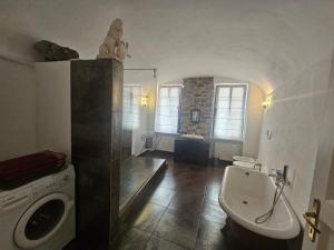 a bathroom with a toilet and a sink and a tub at CASA LEONE BADALUCCO in Badalucco
