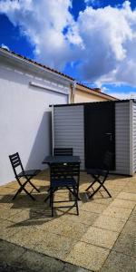 two chairs and a table in front of a building at Maison proche centre, gare, aux Sables d'olonne in Les Sables-dʼOlonne +9 photos