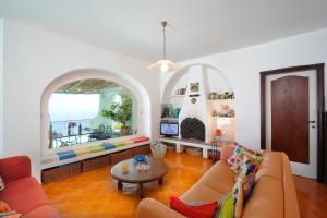 a living room with a couch and a table at Villa Cala del Marò in Praiano